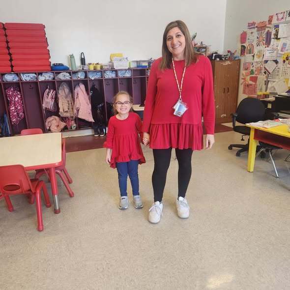 A teacher and student wearing red shirts. 