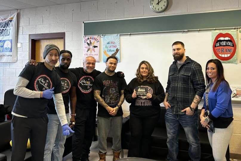 Individuals from Ruiz Barbershop/ Salon and staff from East Middle School. 