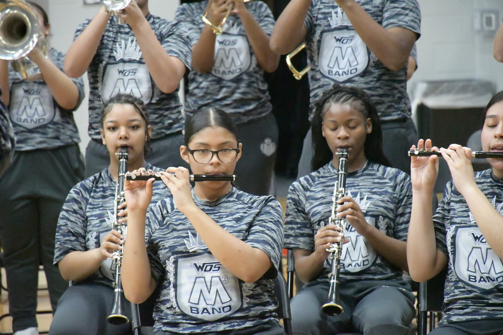 medium shot of the M3 Band performing