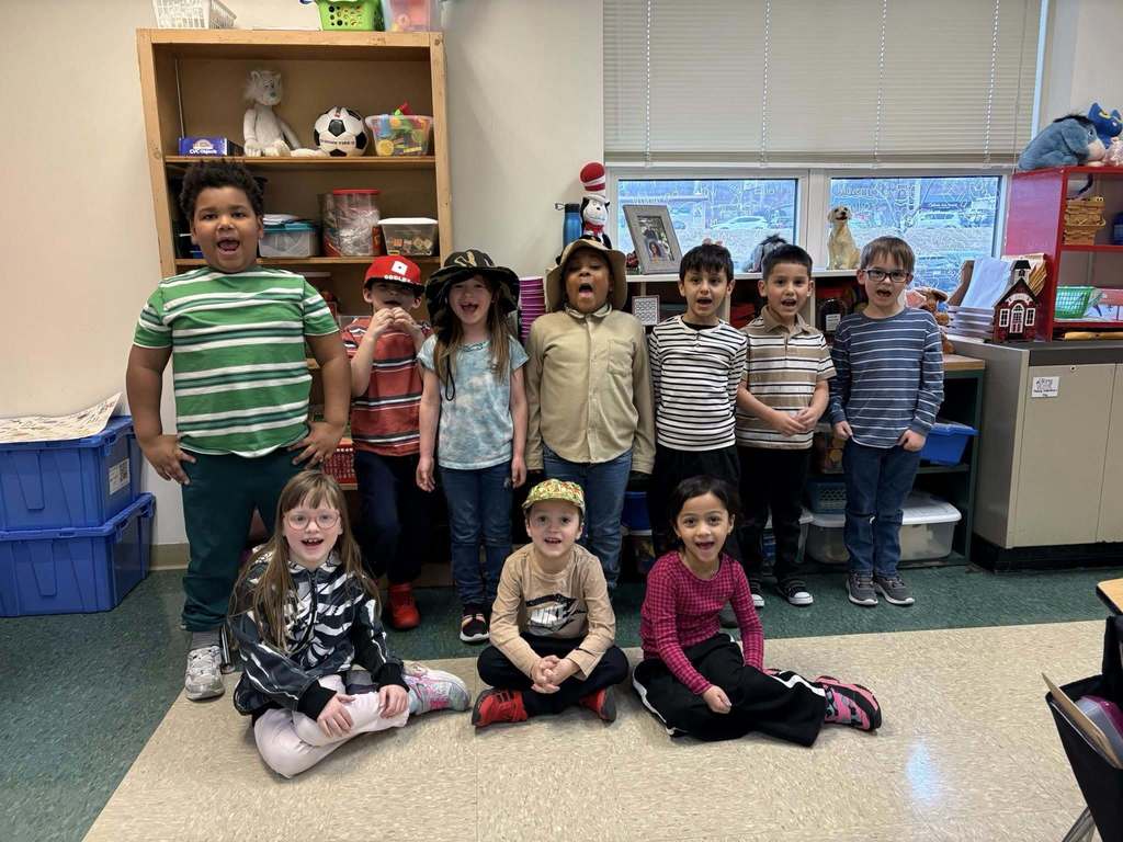 Students wearing striped shirts and some are wearing fun hats. 
