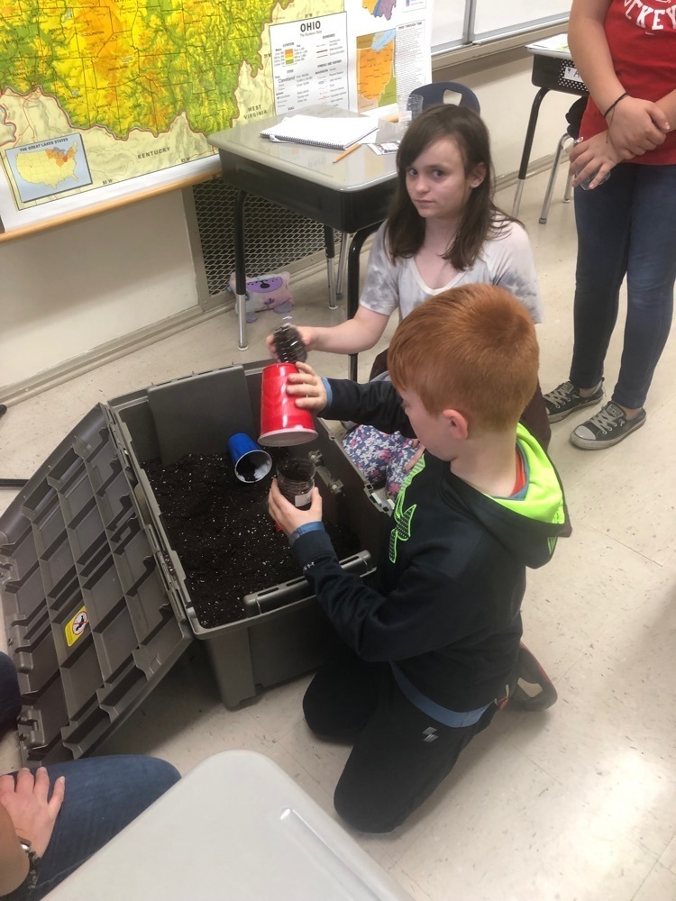 students planting seeds