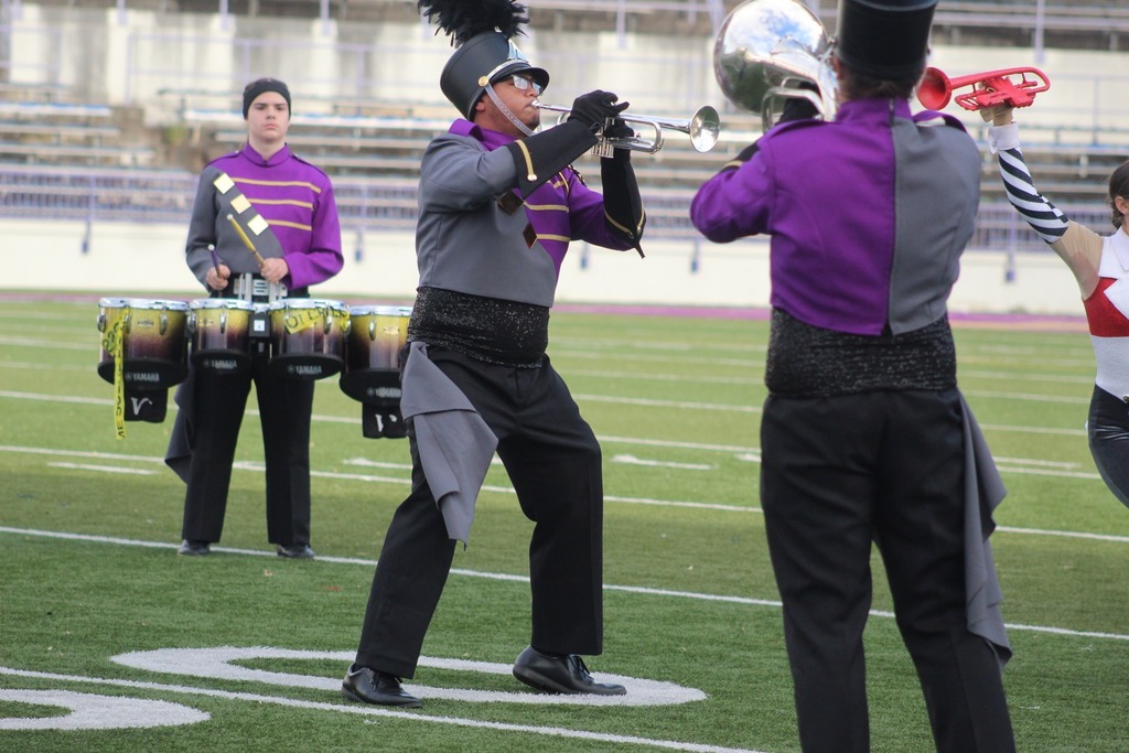 Students playing instruments in the marching band. 