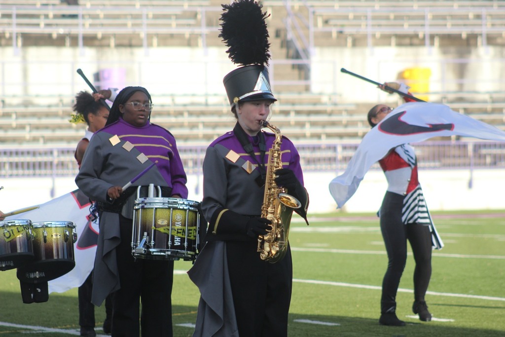 Students playing instruments in the marching band. 