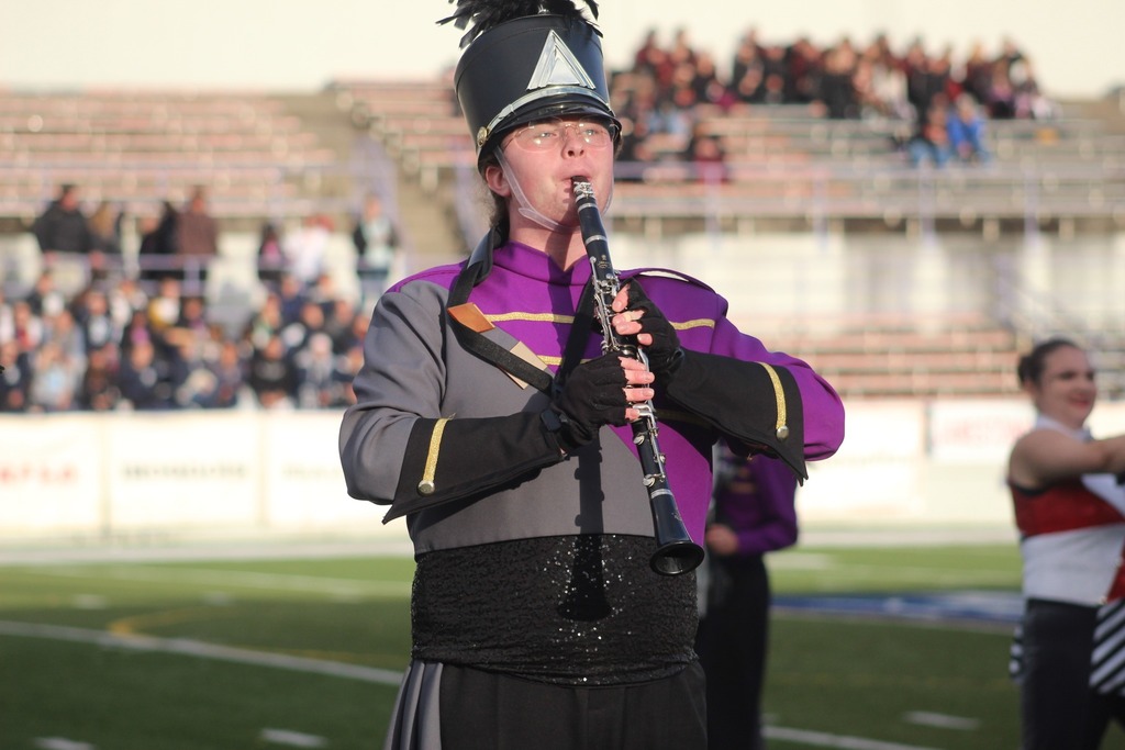 A student playing the flute in the marching band. 