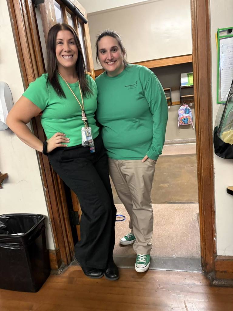 Two teachers wearing green.
