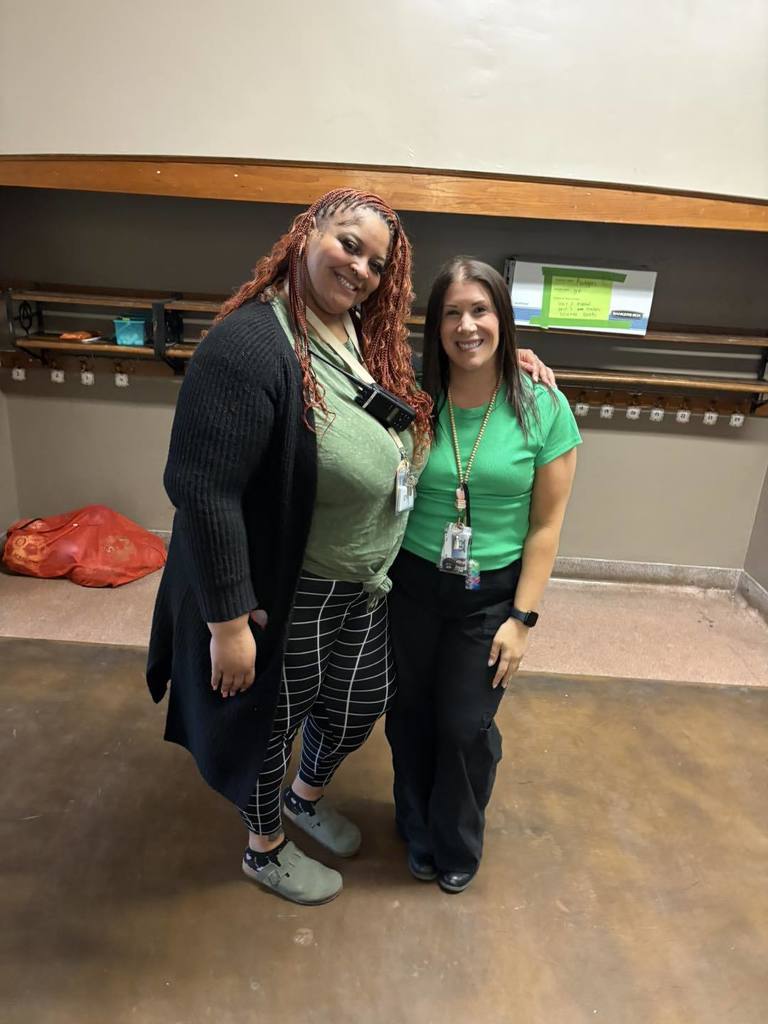 Two teachers wearing green.