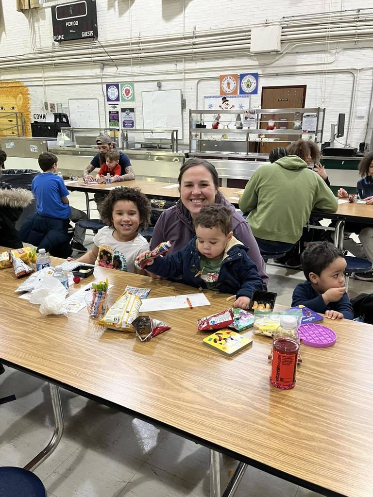 A parent and kids playing bingo.