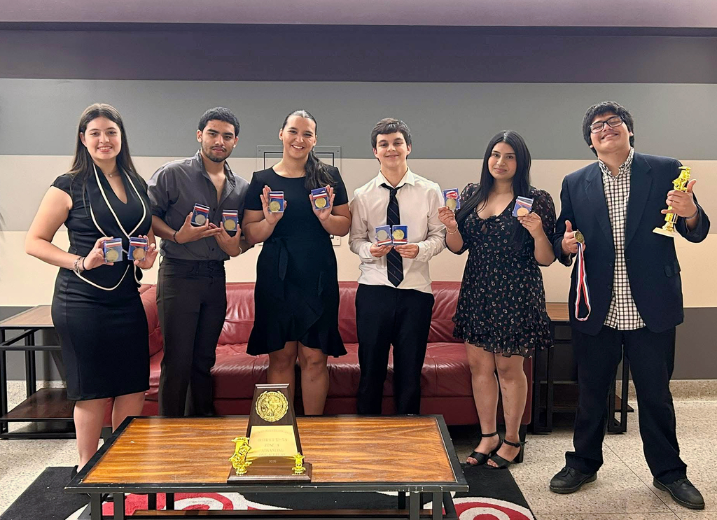 Students holding medals