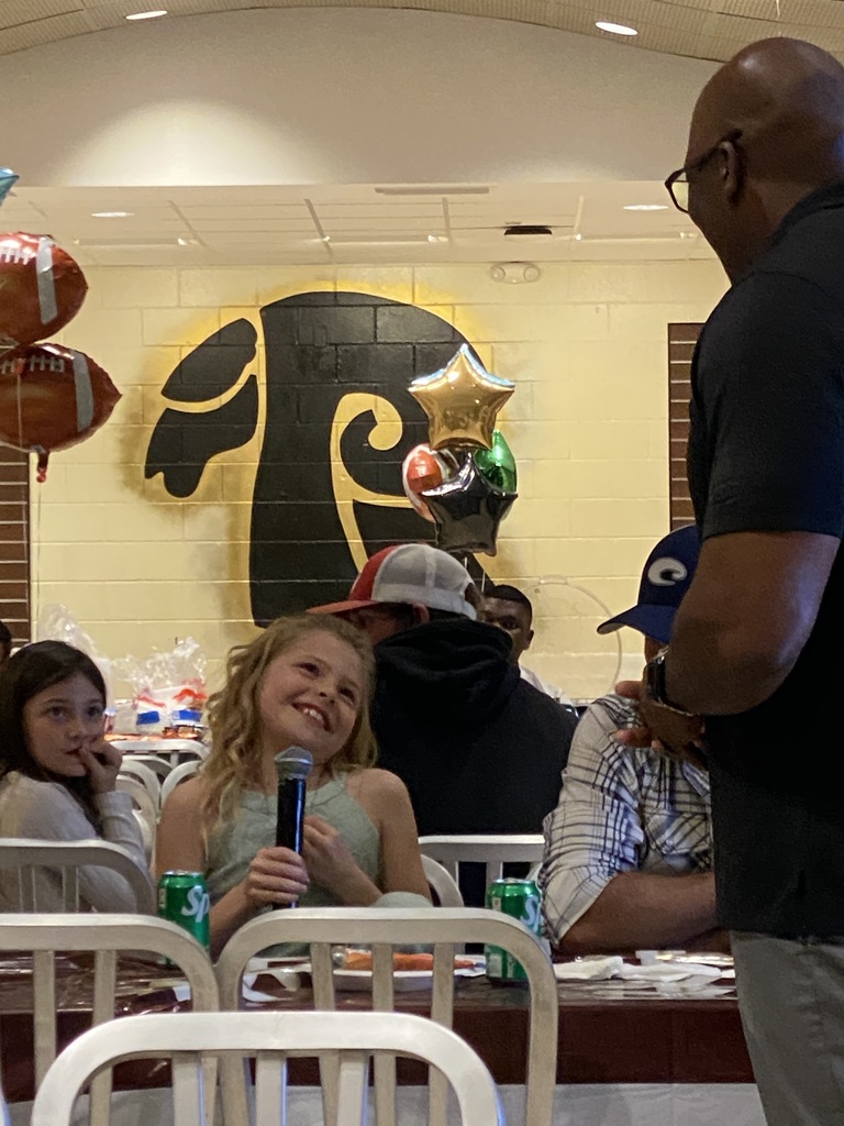 A student takes the microphone and shares her thoughts with the group