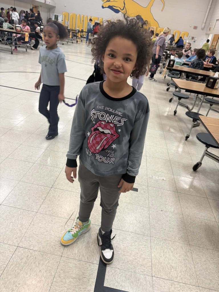 A student wearing two different colored shoes. 