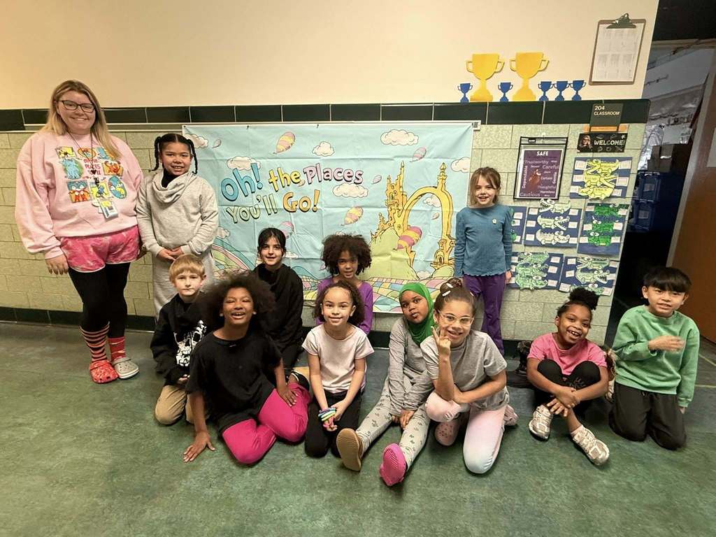 A teacher and students wearing their clothes backwords, inside out, and mismatched for Read across America week. 