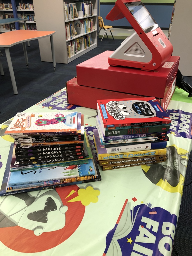 stacks of books and a register at scholastic book fair