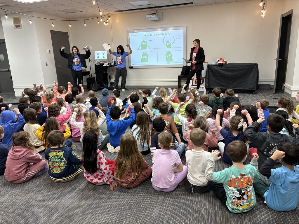 Kindergarten students sharing how they feel today based on the arms character to represent safe tech use.