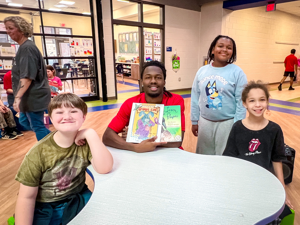 PCHS Service Leadership reading with PCES Trailblazers