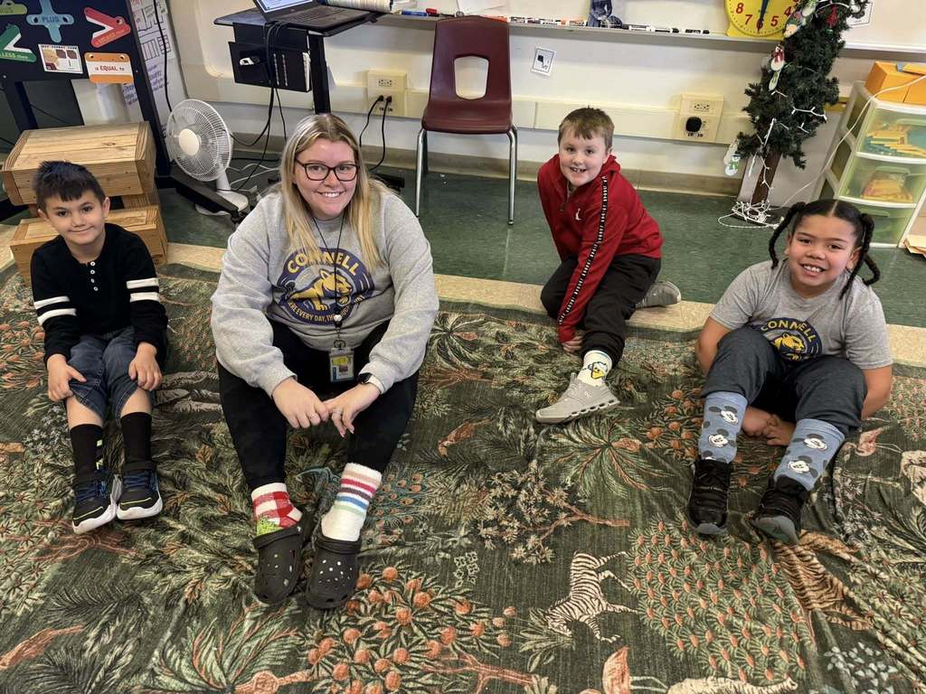 A teacher and students wearing crazy socks. 