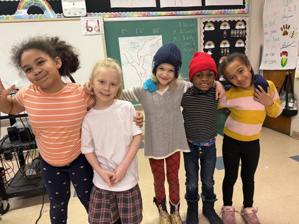 Students wearing striped shirts and fun hats.