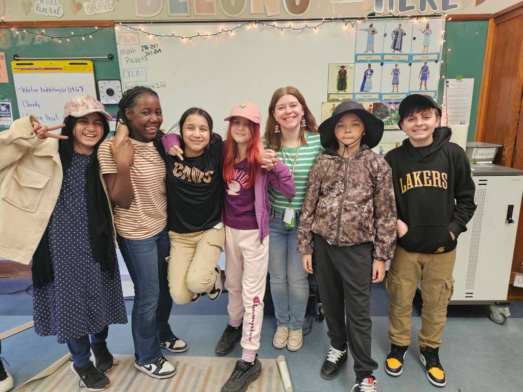 Students wearing striped shirts and fun hats.