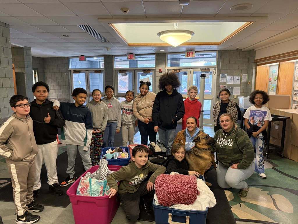 Students holding things they have collected for the anna shelter. 