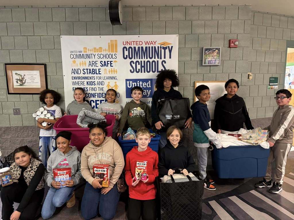 Students holding things they have collected for the anna shelter. 