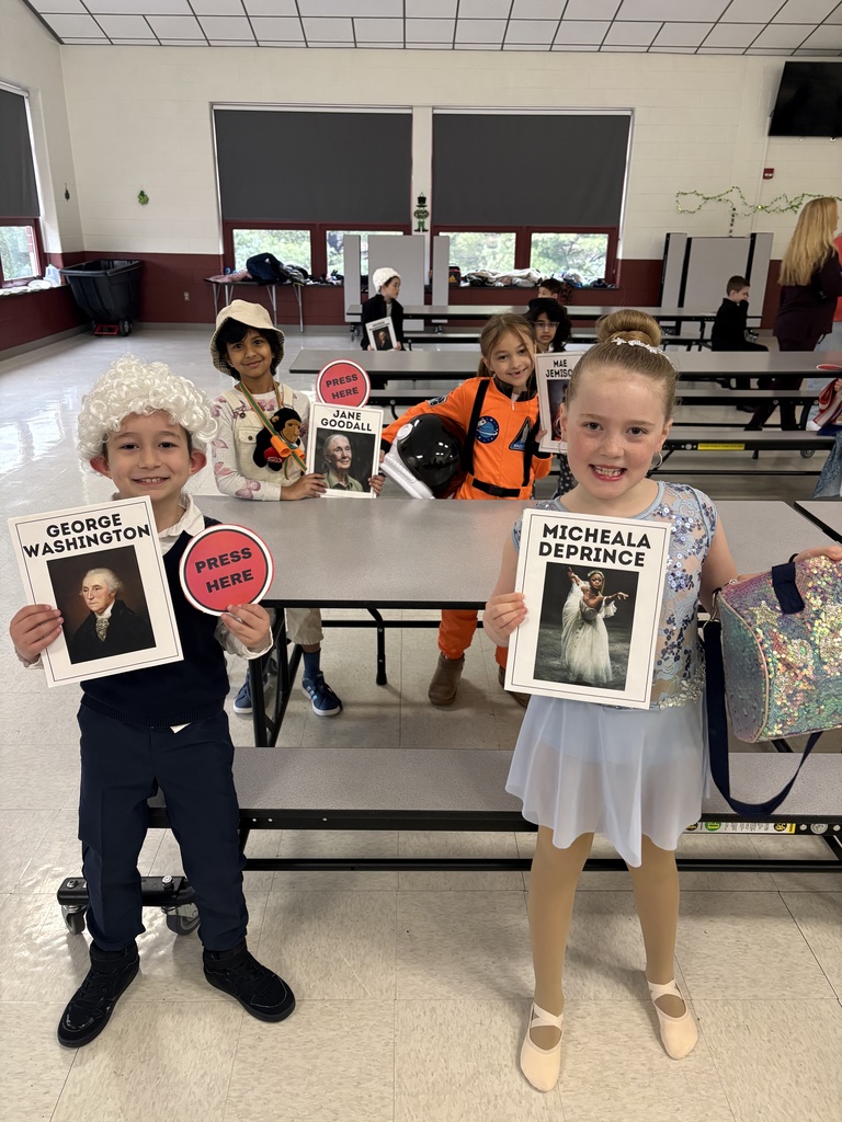 George Washington, Micheala DePrince, Jane Goodall, and Mae Jemison smiling with their posters.