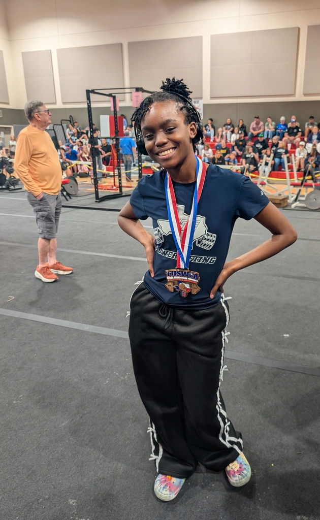 WOS powerlifter posing with medal