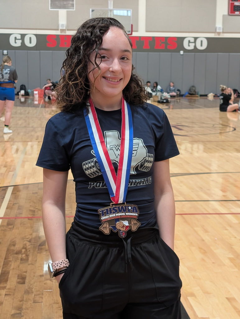 WOS powerlifter posing with medal