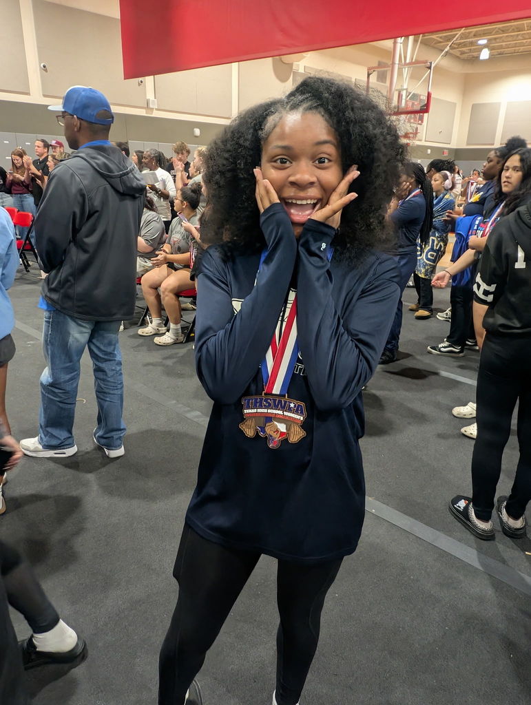 WOS powerlifter posing with medal