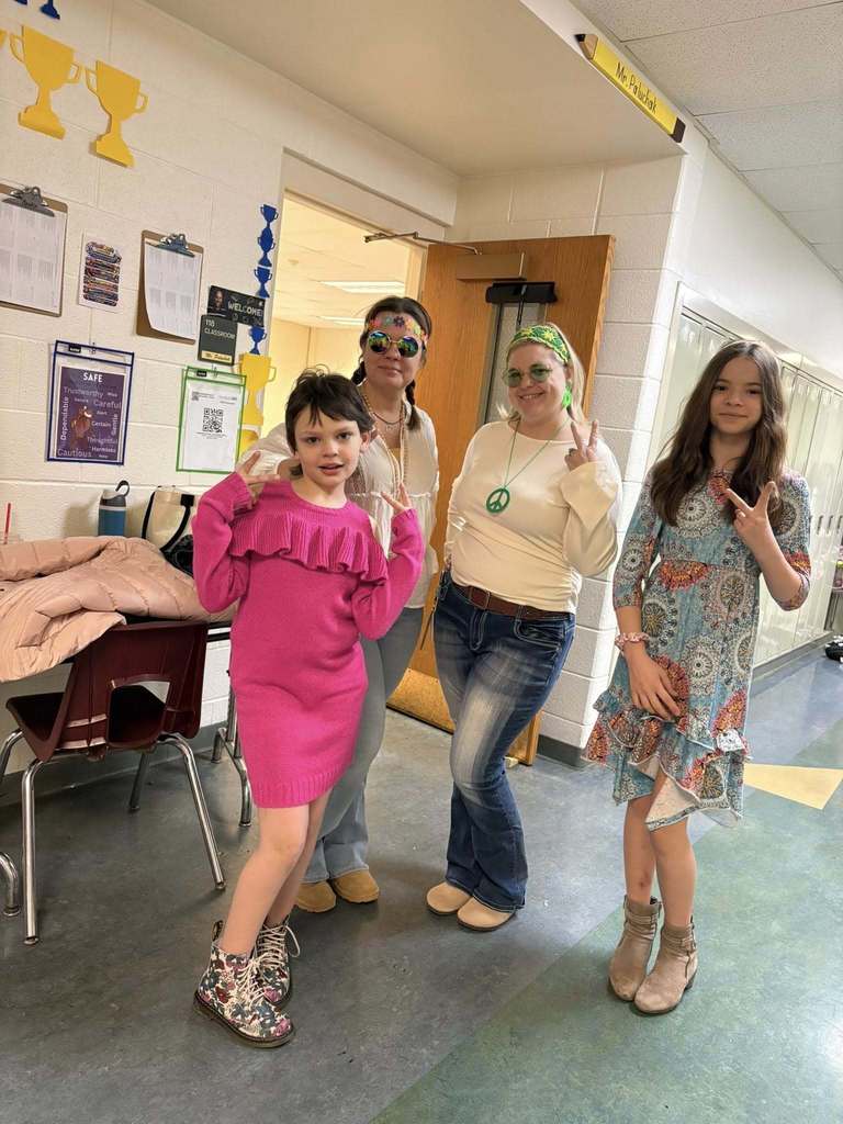 Teachers and students dressed to look like they are from the 70s. 
