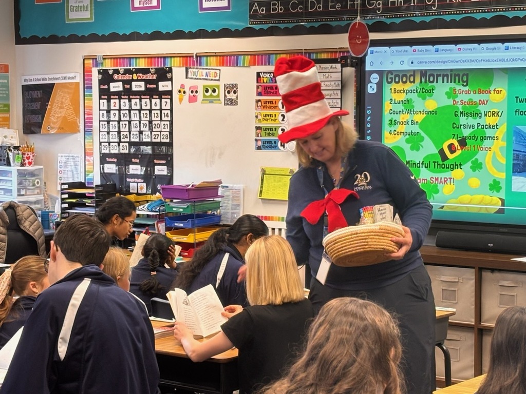 principal in cat in the hat hay giving pencils and bookmarks out