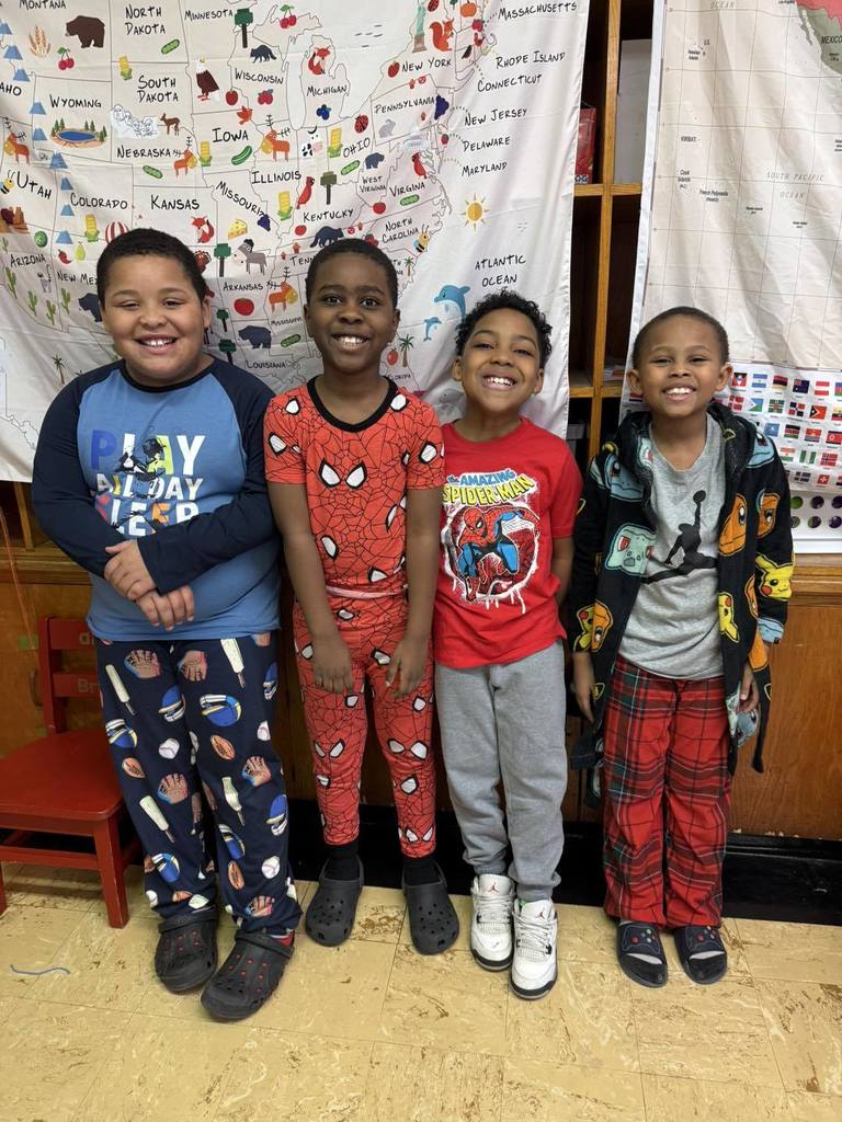 Students wearing pajamas and smiling.