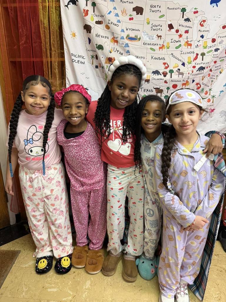 Students wearing pajamas and smiling.