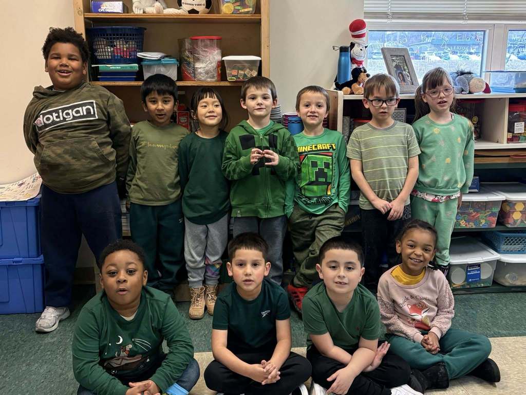 Students wearing green in a classroom. 