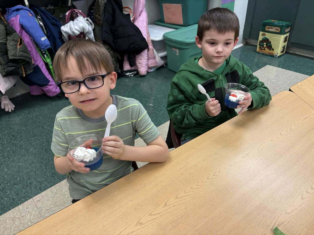 Students holding their snack in a cup for Dr. Seuss week.