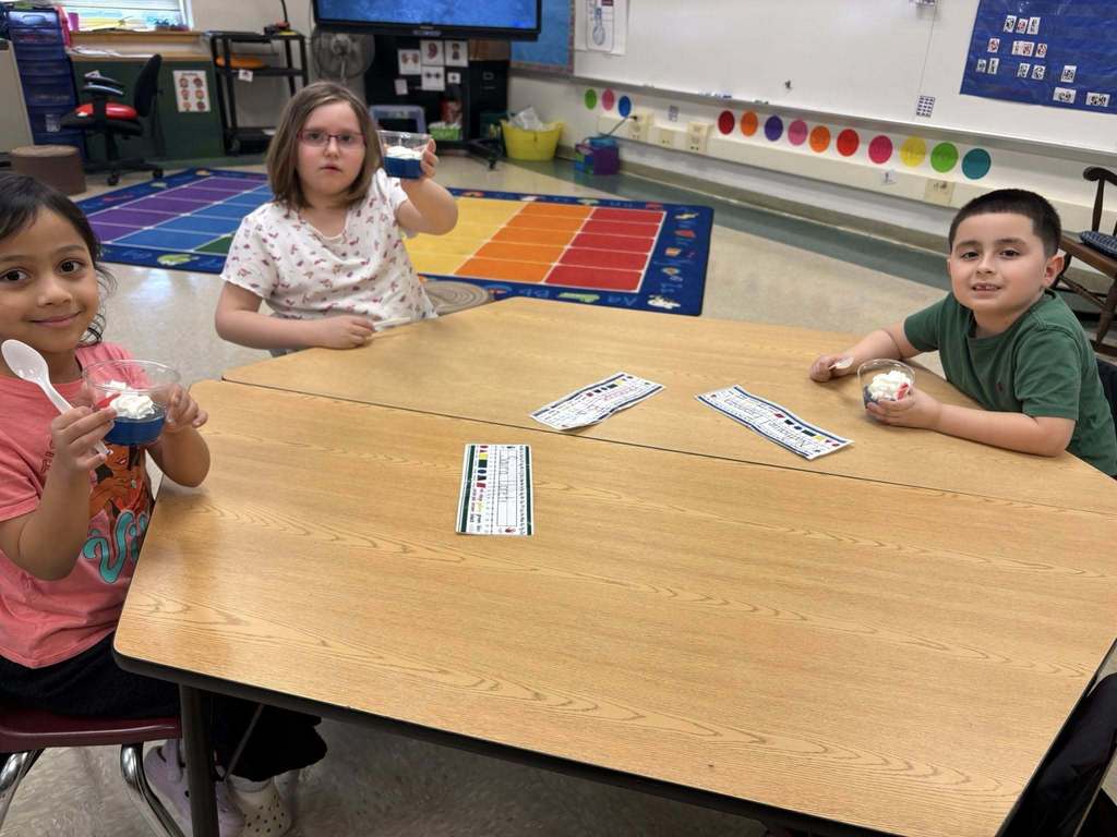 Students holding their snack in a cup for Dr. Seuss week.