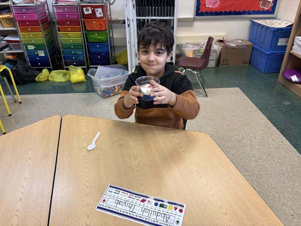 A student holding their snack in a cup for Dr. Seuss week.