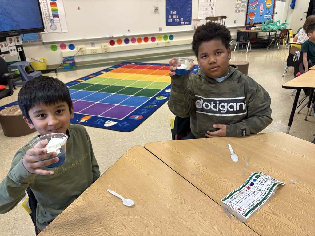 Students holding their snack in a cup for Dr. Seuss week.