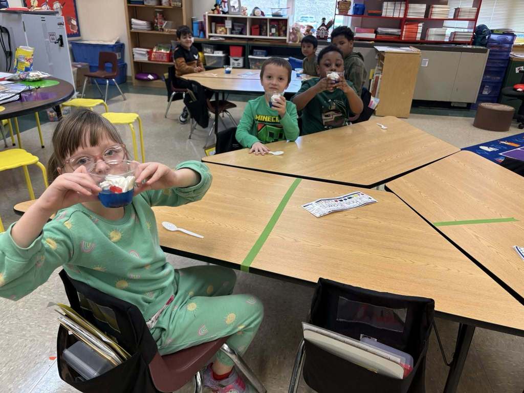 Students holding their snack in a cup for Dr. Seuss week.