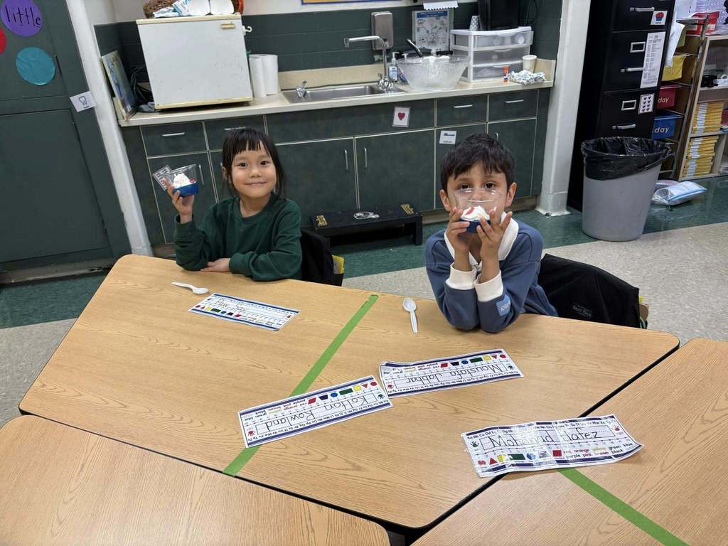Students holding their snack in a cup for Dr. Seuss week.