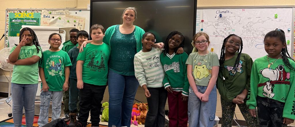 Students and teacher are wearing green. 