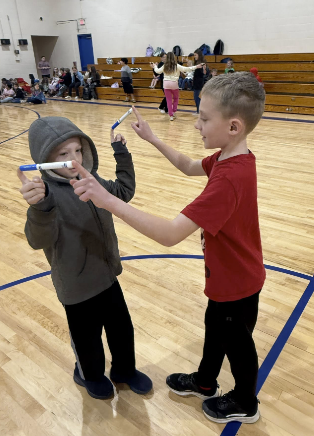 All Together Now! 💙💛💚❤️ Today our Houses kicked off with an assembly full of teamwork, laughter, and just a little bit of strategy! Students competed in a race across the gym, but there was a catch! Each team had to get every member from one end to the other while staying connected using only one finger and a marker. No breaking the chain! It was the perfect way to launch our March Character Strong focus: Collaboration. Students quickly learned that success wasn’t about speed alone — it was about communication, patience, encouragement, and working together toward a common goal. These schoolwide assemblies are powerful for our students and our staff. While students build relationships and school spirit, our teachers gain valuable time to collaborate and dive into data to better support every learner. We are stronger when we work together. 💪 #AllTogetherNow #CharacterStrong #Collaboration #HousePride