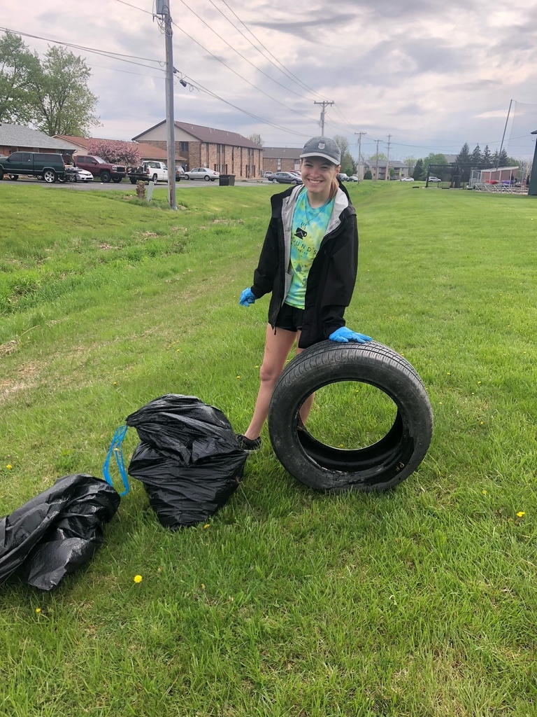 A volunteer shows the trash she collected around the schools.