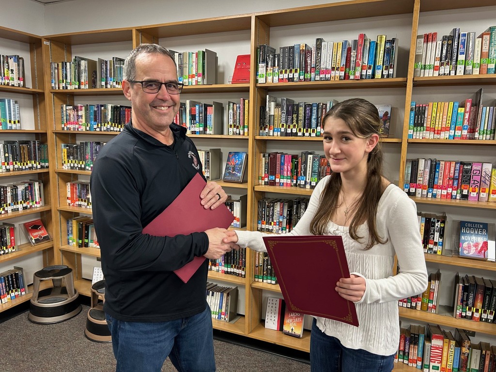 Optimist Club President Chuck Hillman presents Katie DePinto with a certificate and gift card for essay win