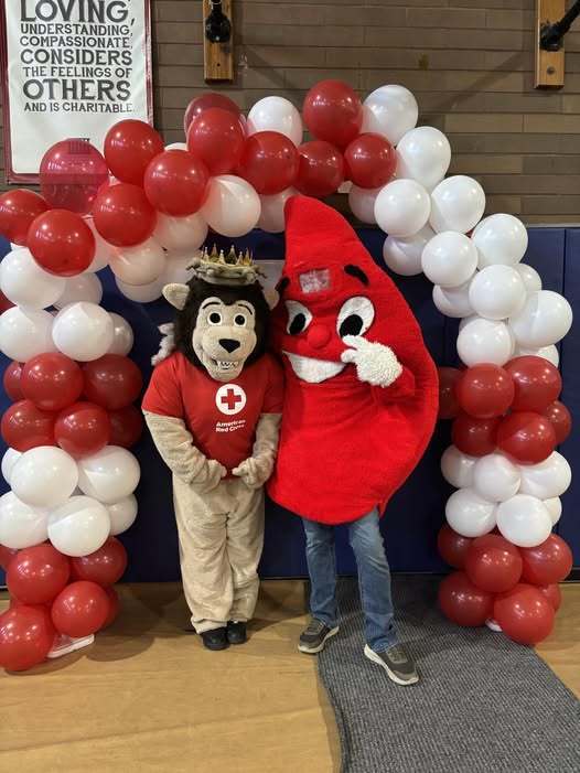 A blood drop and the Erie High School mascot wearing a American Red Cross shirt.