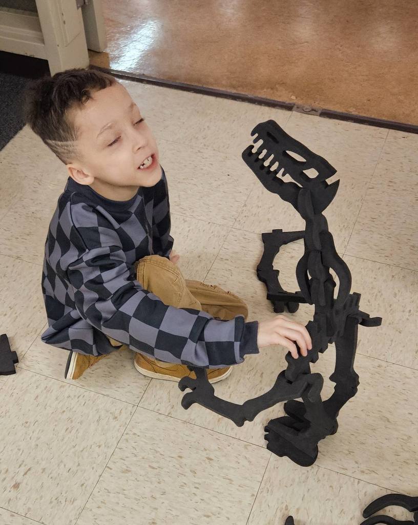 A kid made a dinosaur using foam bones. 