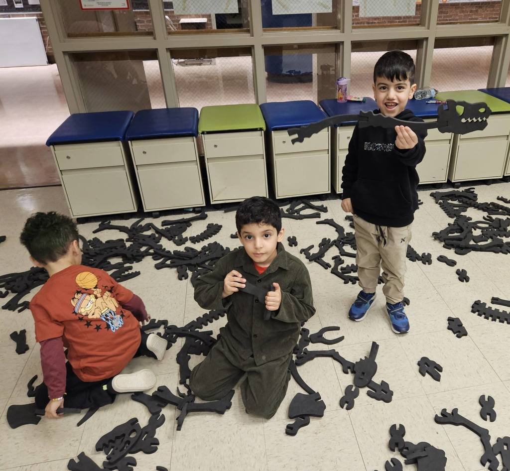 Kids making a dinosaur using foam bones. 