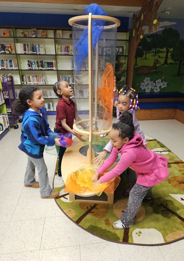Kids playing with fabric and a tunnel. 