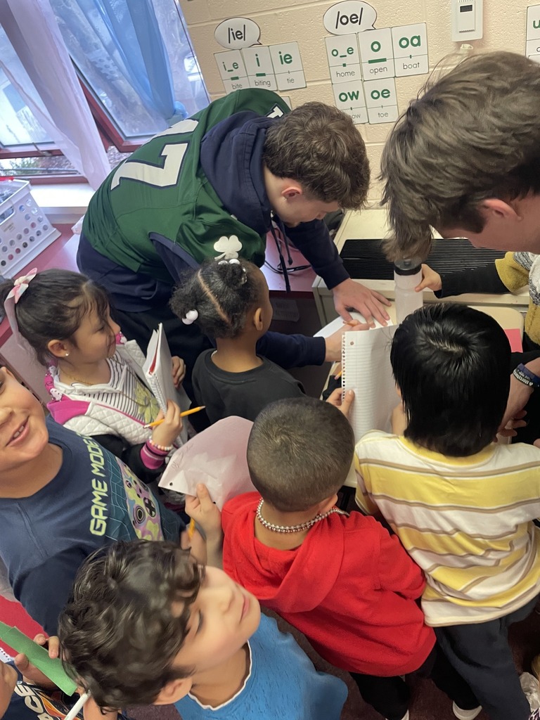 Mercyhurst University Football players giving autographs to students.