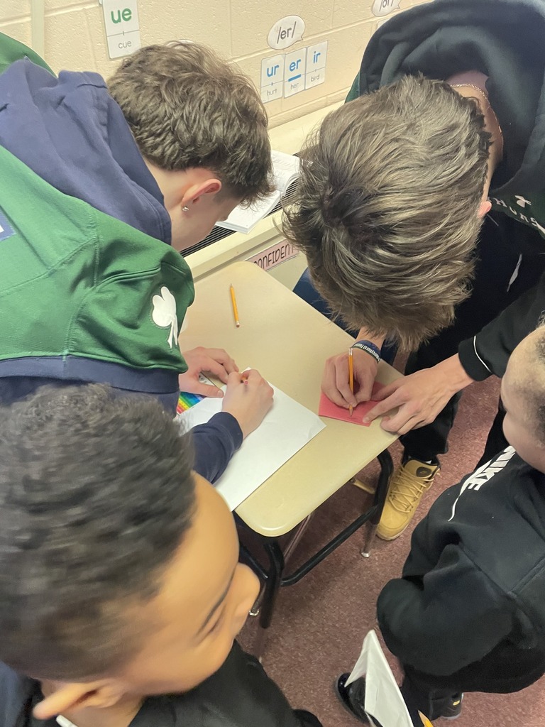 Mercyhurst University Football players giving autographs to students.