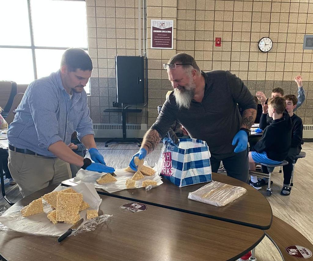 Two staff members at a school activity