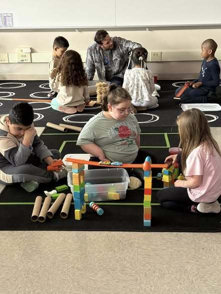 Students playing with building blocks. 